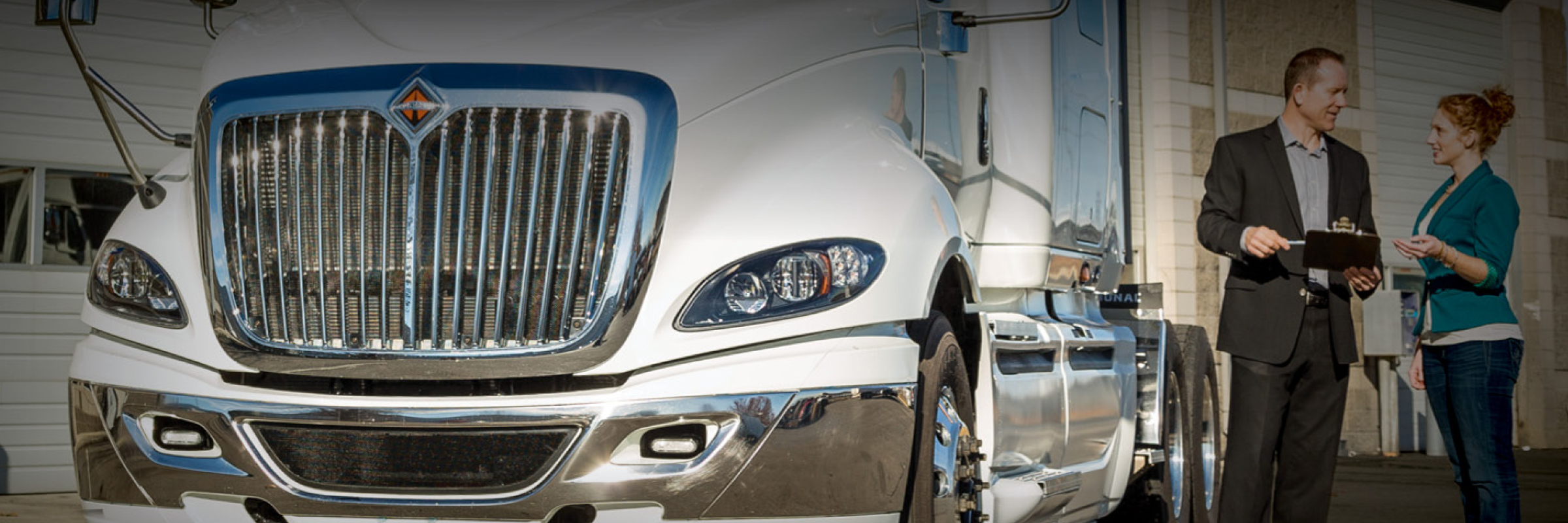 Employee talking to customer next to truck | Used Truck Sales | Used Trucks for Sale