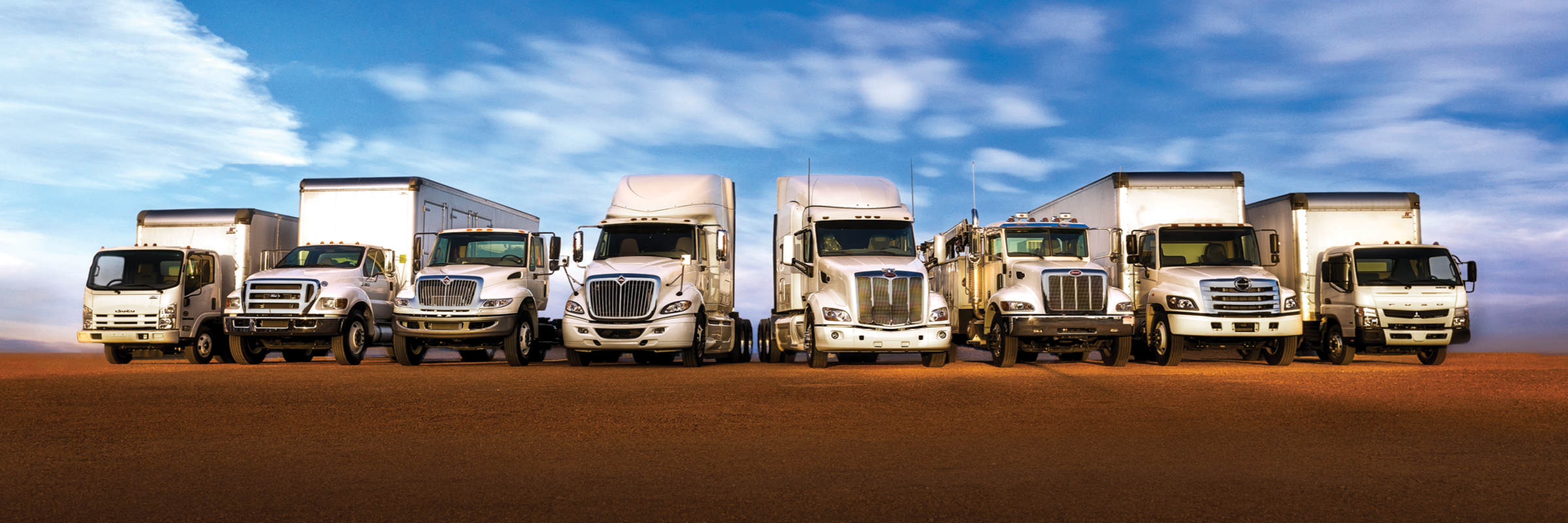 Line up of used trucks | Isuzu, International, Peterbilt, Hino, Mitsubishi Fuso, and Ford trucks